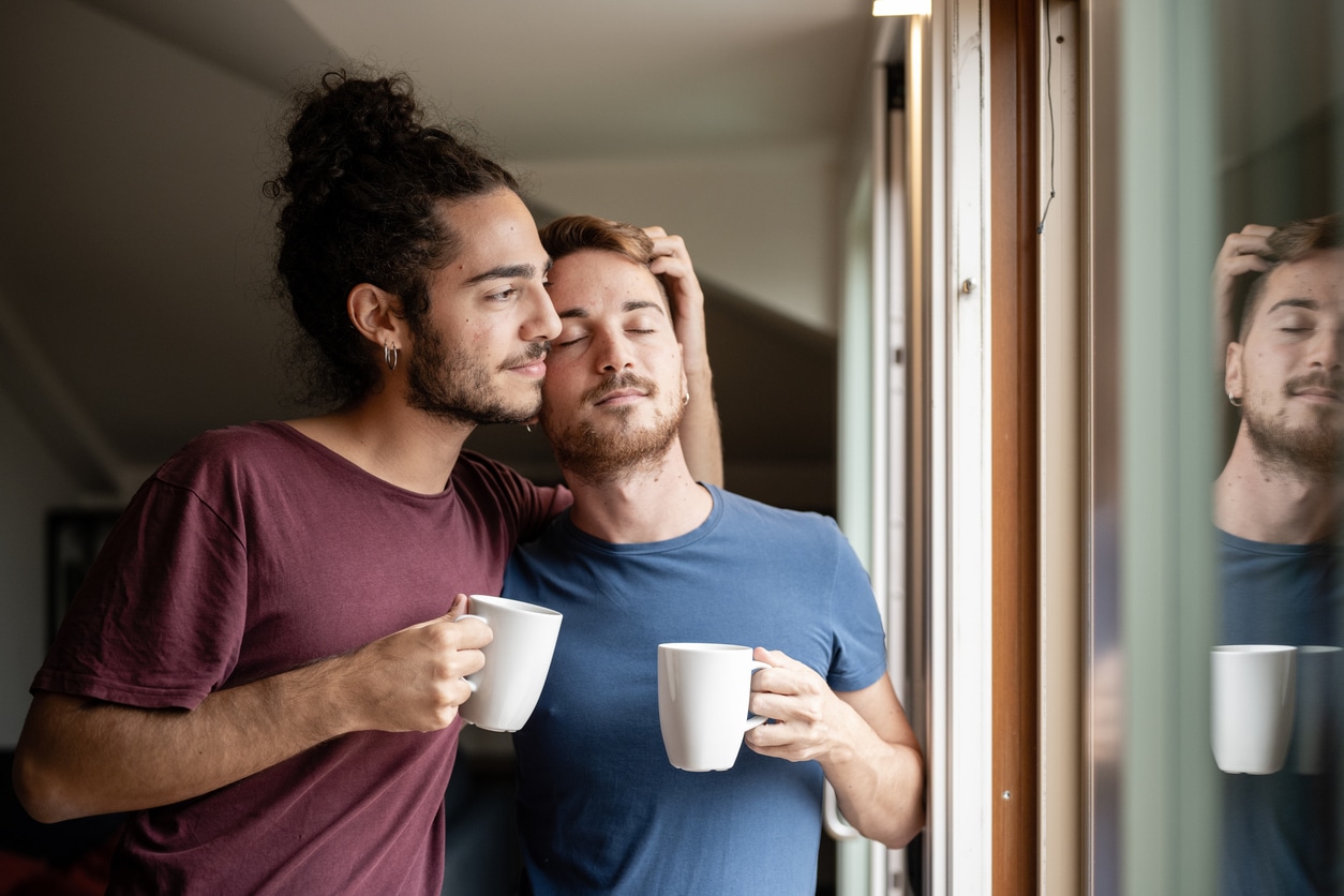 Why do you feel sleepy when someone plays with your hair? Male couple touching hair with eyes closed.