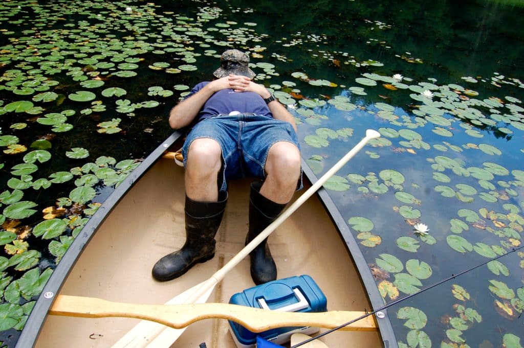 Why does fishing make you tired? Fisherman asleep in his fishing boat.