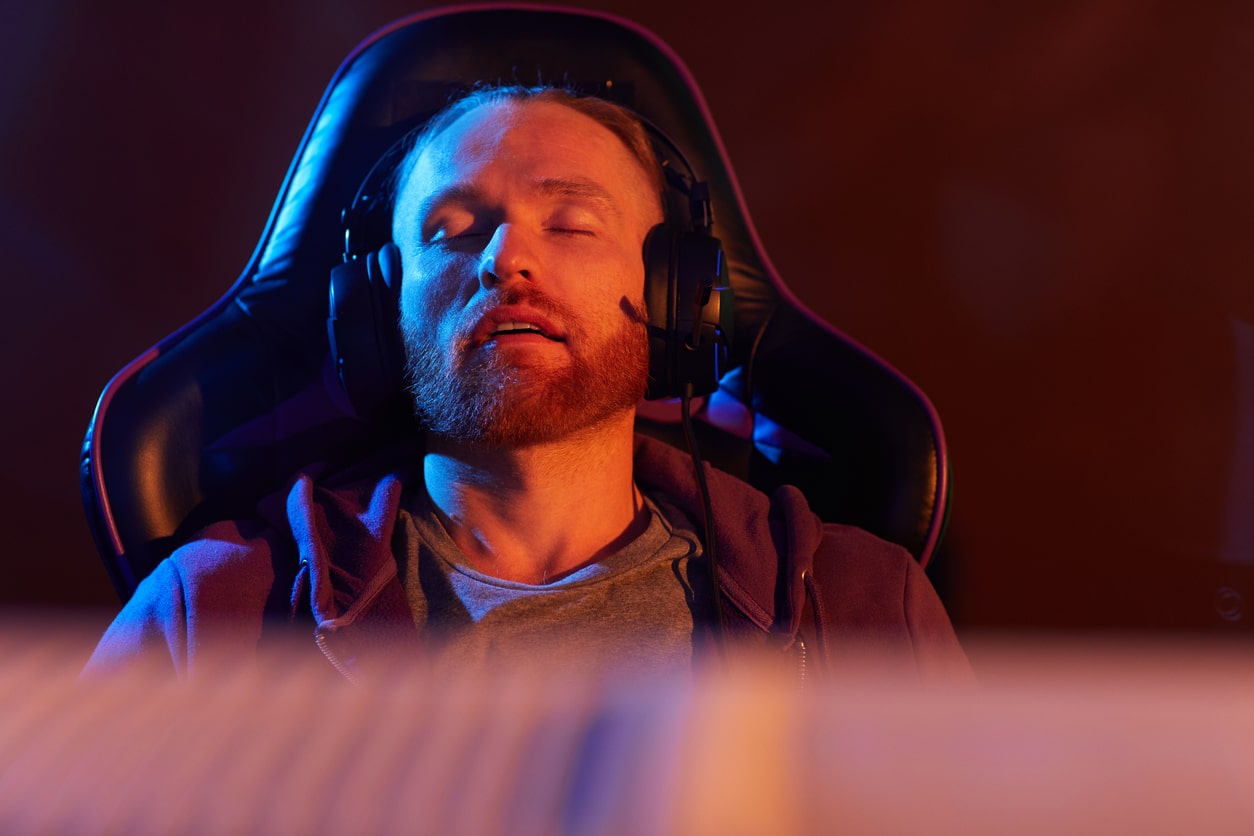 why does gaming make me tired? man asleep in gaming chair