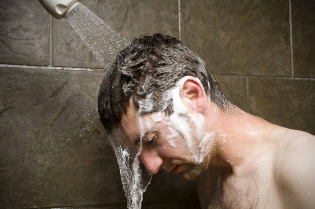 Why do I get sleepy after taking a shower? Man feeling tired in shower.