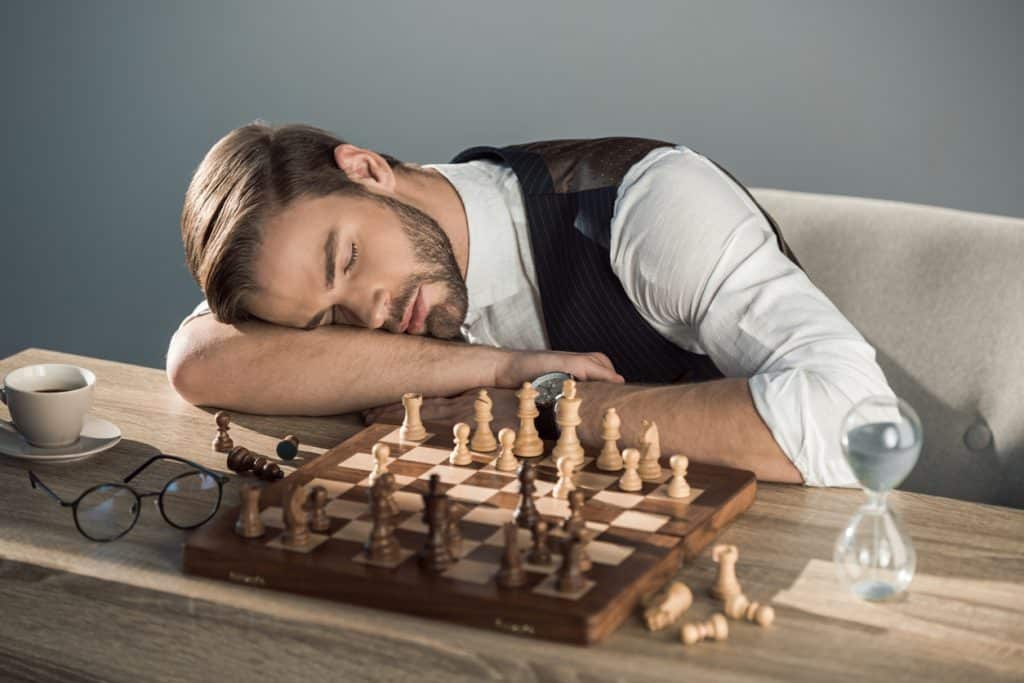 Why do board games make me tired? Man asleep in front of board game.